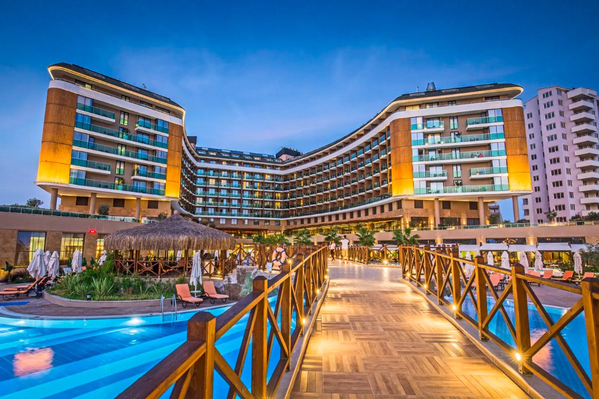 Aska Lara Resort & Spa – verlicht zwembad en hoofdgebouw bij avond
